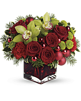 Christmas Floral Arrangements Filled with Red Roses, Red Carnations, Forest Greens in Red Cube Vase by Teleflora | Same Day Flower Delivery