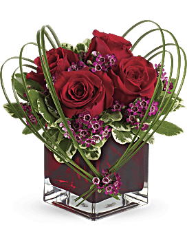 Red Roses & Purple Waxflower, Variegated Pittosporum, Bear Grass In A Red Glass Vase. Teleflora Sweet Thoughts Bouquet.